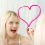 Young beautiful woman drawing big heart on mirror.