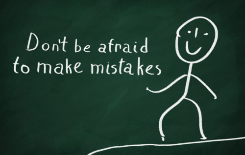 On the blackboard draw character and write Don't be afraid to make mistakes